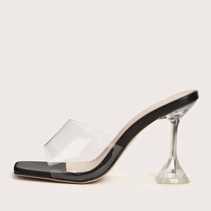 Clear sculptural heeled mules